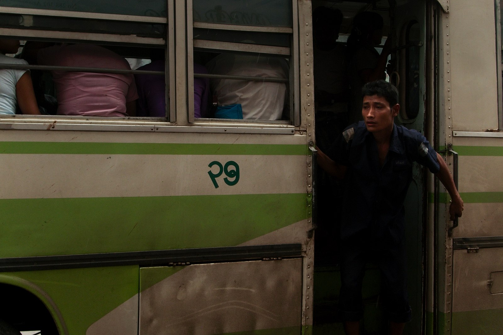 One of the most curious jobs at Myanmar: the guy at the bus calling for customers, This one’s at Yangon downtown.